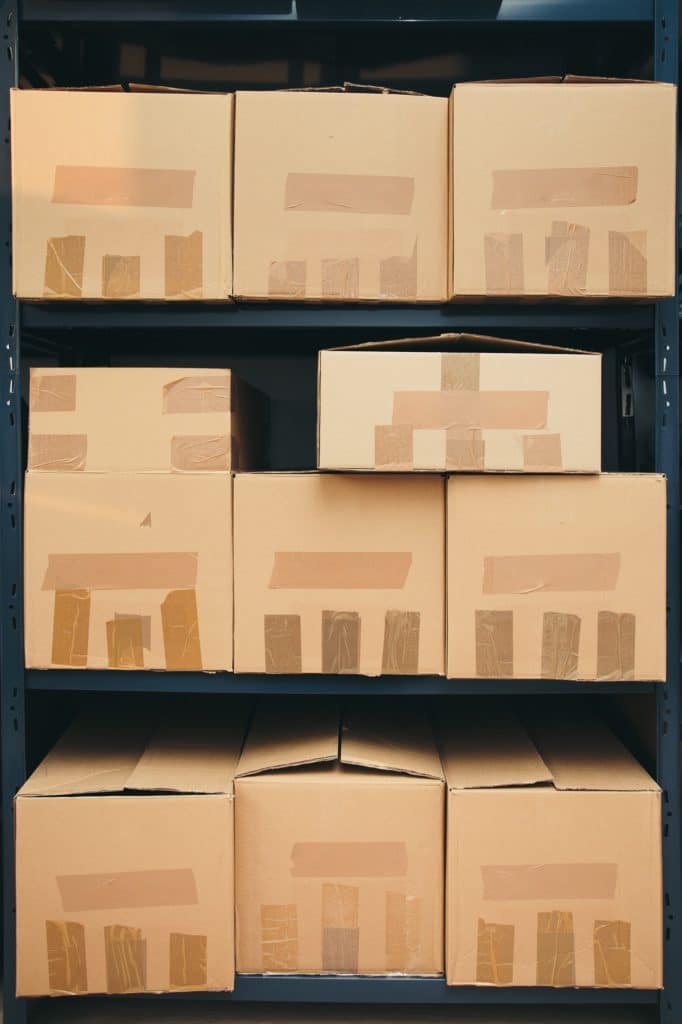 Cardboard boxes on shelves. Packages in warehouse. Boxes in depot. Storage for goods